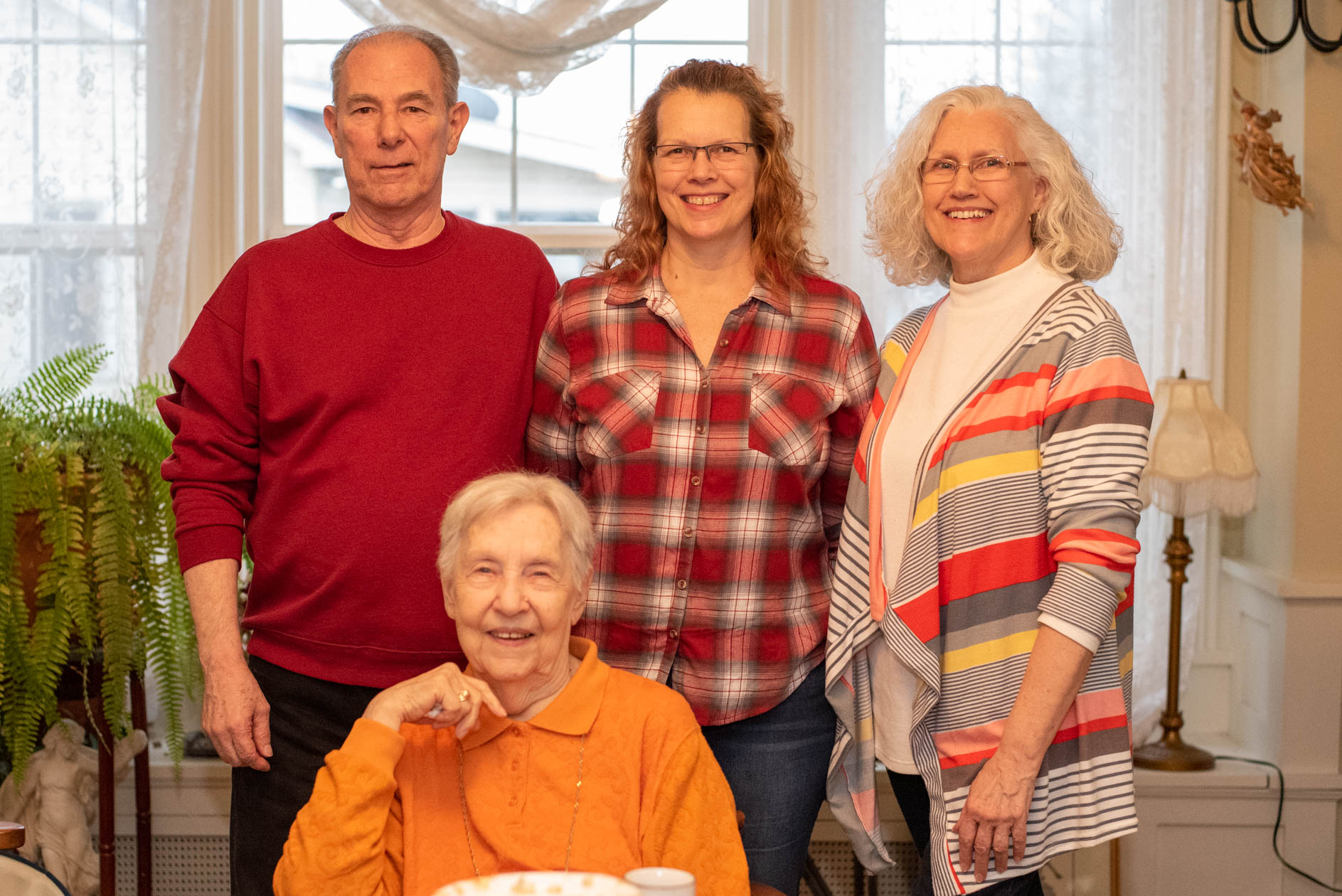 Group family photo of four elderly adults.